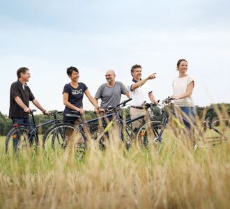 Personen auf Fahrrädern in einem Feld